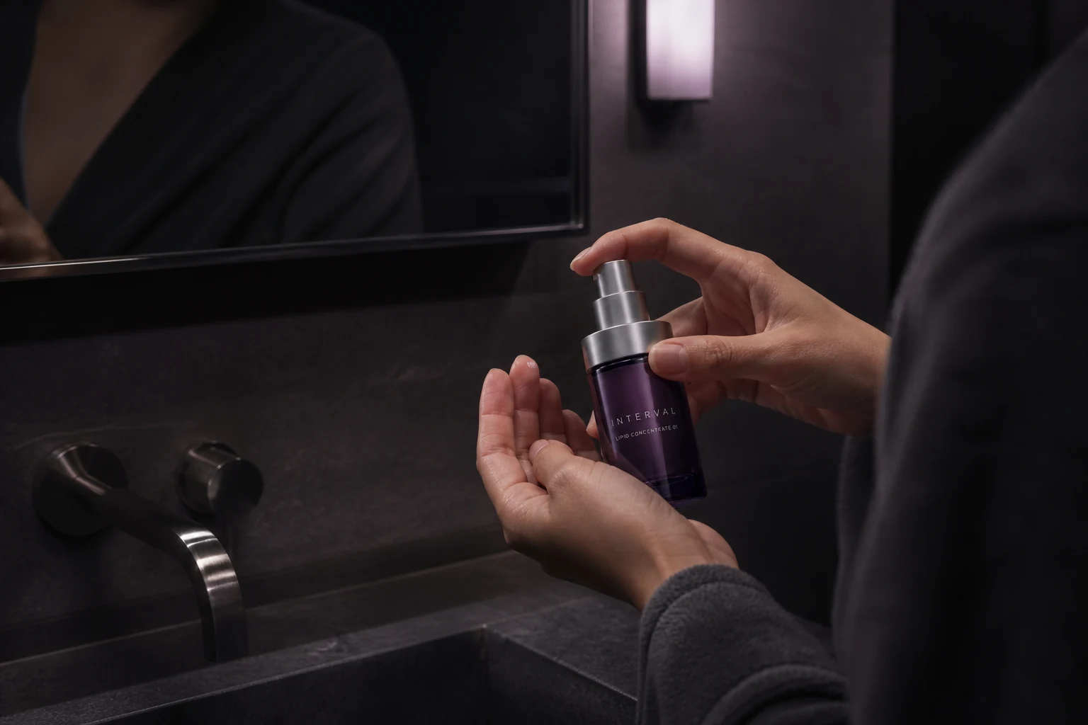 Evening INTERVAL skincare ritual in a dark modern bathroom